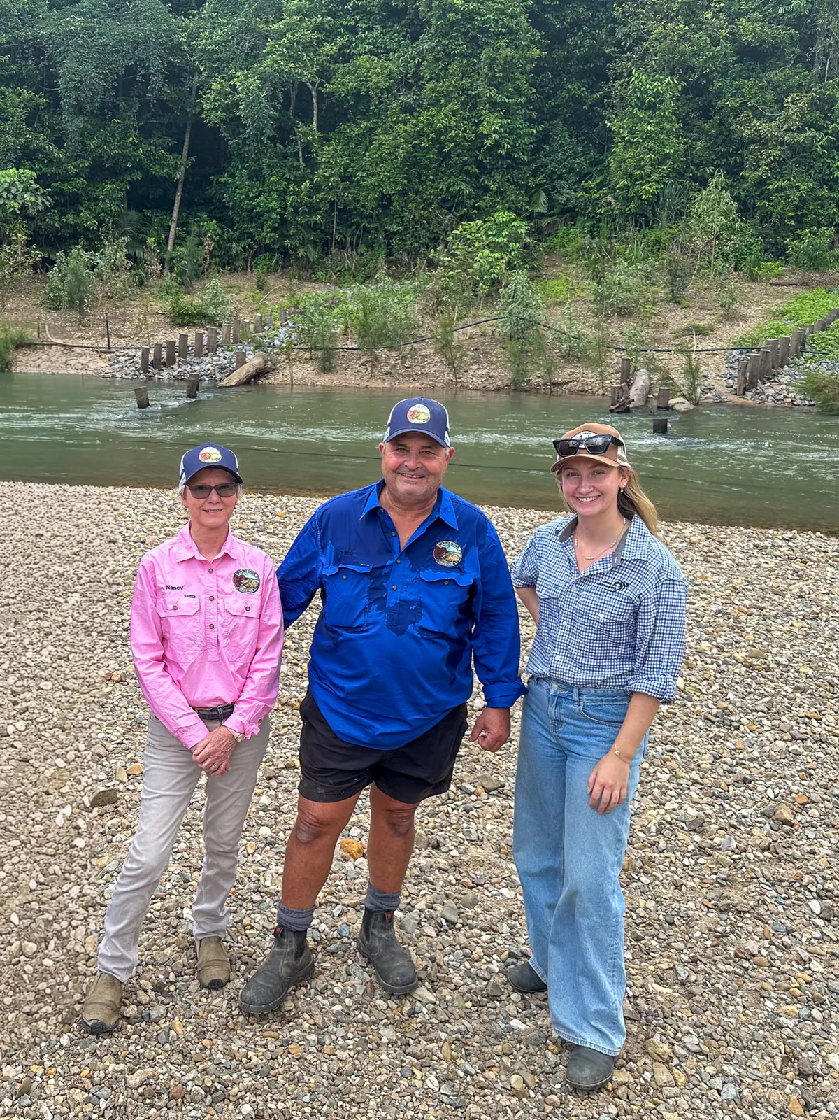 Peter and Nancy Baretta with Emily Wilson beside Murray Creek