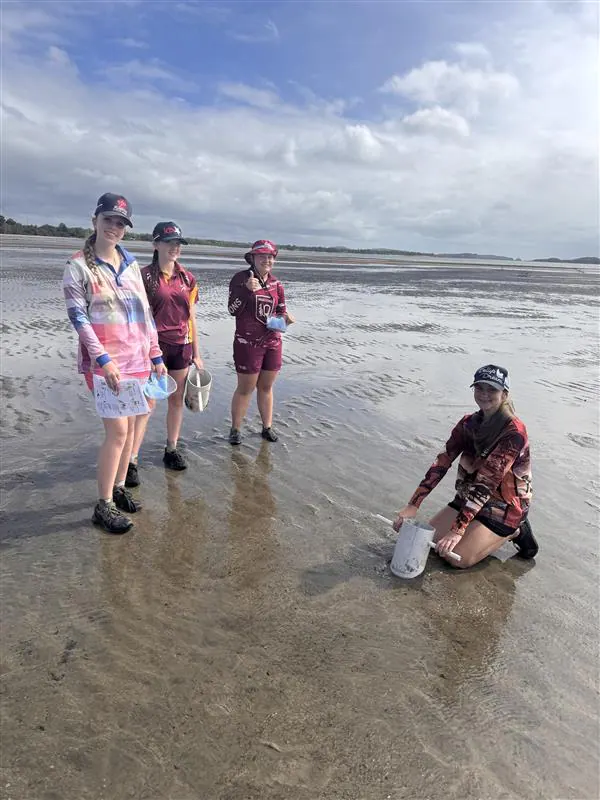 Community members sampling on the beach at low tide